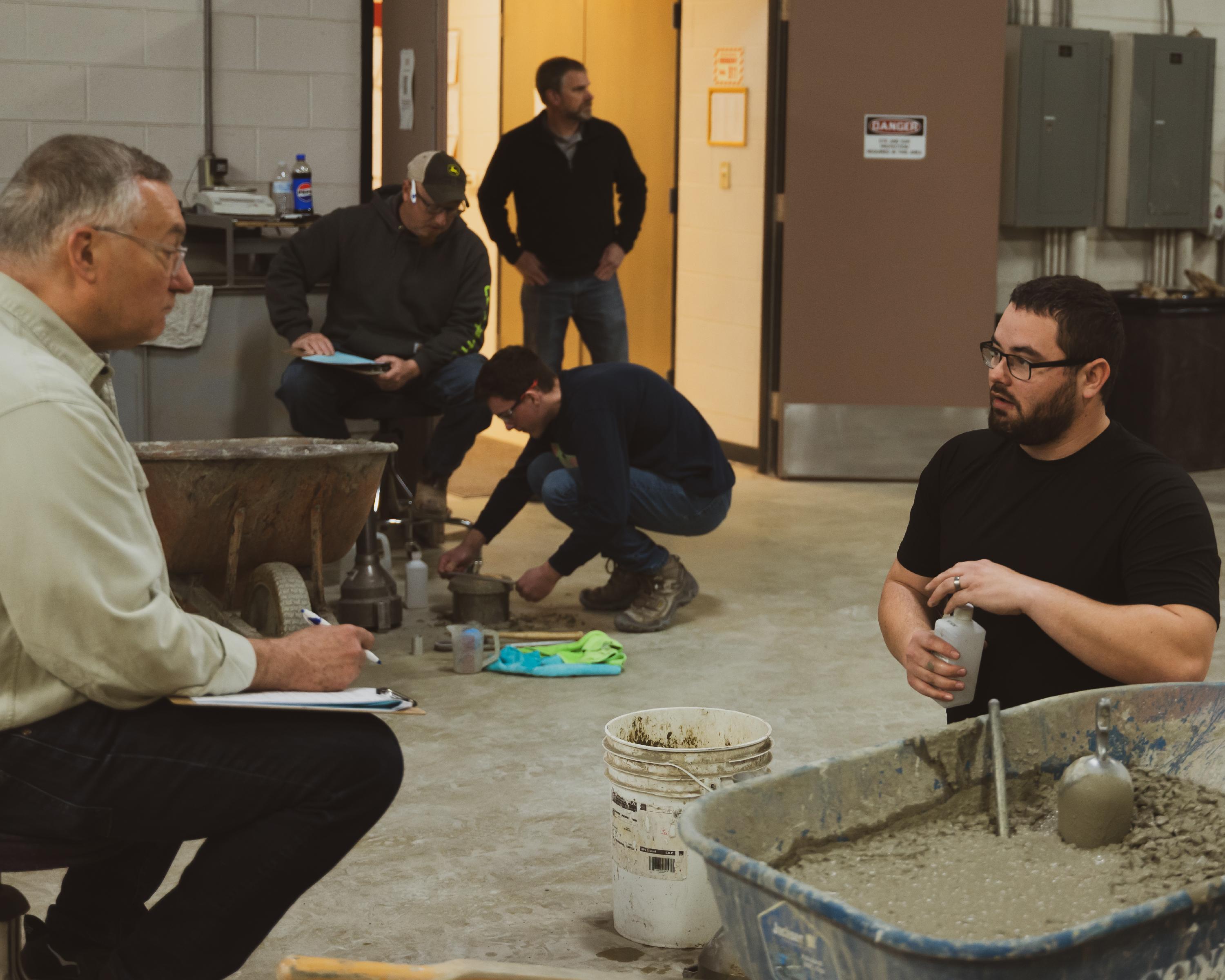 Student being evaluated in concrete testing lab